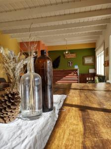 two glass vases sitting on a table in a room at Hostel Yatel in El Calafate