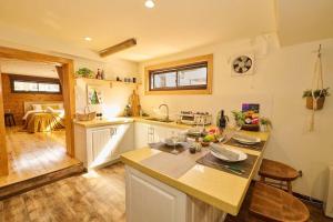 a kitchen with a table and a counter top at Sunnsnow ski in apartment in Otari +6 photos