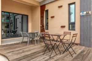 a patio with a table and chairs on a deck at Summer Crazy in Huxi