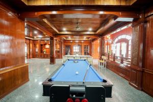 a pool table in a room with wooden walls at The Star Pool Villa Hatyai in Hat Yai