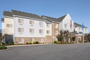 a large apartment building with a parking lot at Fairfield Inn & Suites Naperville/Aurora in Naperville