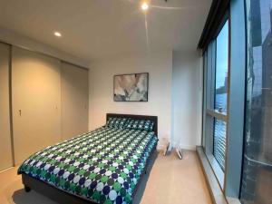 a bedroom with a bed and a large window at Chic 2BR Luxury Apt in Prime West Side Complex Center of It All in Melbourne +34 photos