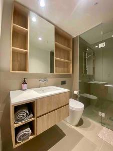 a bathroom with a sink and a toilet and a shower at Chic 2BR Luxury Apt in Prime West Side Complex Center of It All in Melbourne