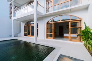 a house with a swimming pool in front of it at Campbar 4 by AGATA in Canggu +50 photos