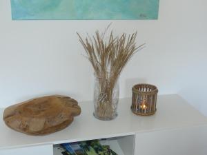a table with a vase and a candle on it at Appartement Buchstein in Mistelbach