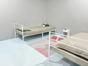 a room with two bunk beds and a rug at KB Penang Guest House in Kepala Batas