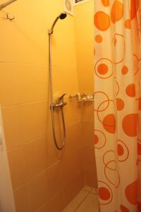 a shower stall with a blue shower curtain at WHotel Kyiv in Kyiv