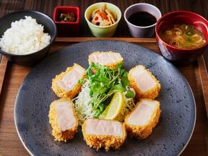a plate of food with meat and salad and rice at APA Hotel & Resort Osaka Namba Ekimae Tower in Osaka