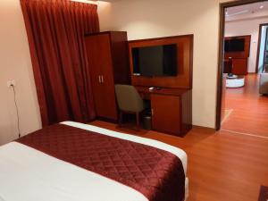Postel nebo postele na pokoji v ubytování Park Avenue Hotel & Apartments Trichy