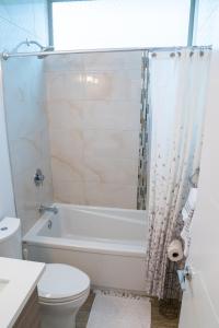 a bathroom with a tub and a toilet and a sink at Explore Seattle Free Parking & Walk to Light Rail - New listing & ABNB Superhost in Seattle