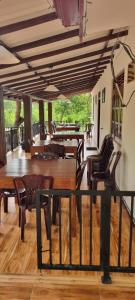 a dining room with wooden tables and chairs at Yala Reach Hotel in Tissamaharama