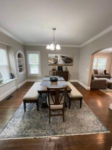 a living room with a table and chairs in it at Historic District Home in Russellville
