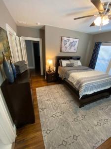a bedroom with a bed and a ceiling fan at Historic District Home in Russellville