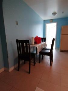 a dining room with a table and two chairs at Bedroom with double bed in Mississauga +4 photos