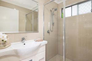 a bathroom with a sink and a shower at Smart Suites Self Check-in Apartments - Rocklea Station N in Brisbane +53 photos