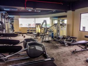 a gym with treadmills and machines in a room at Fancy and Nice Studio at Atria Residence Gading Serpong Apartment By Travelio in Tangerang