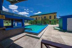 a swimming pool in the backyard of a house at Airport Suites Hotel in Piarco
