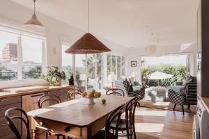 a kitchen and living room with a table and chairs at House on The Hill in Hobart