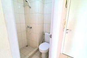 a bathroom with a toilet and a shower at Springlake summarecon in Rawabugel