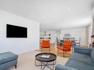 a living room with a couch and a table at Greenhills Charmer - Coromandel Town Holiday Home in Coromandel Town