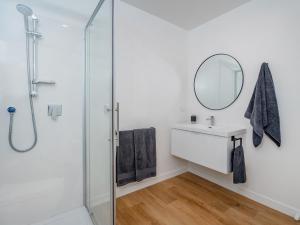 a bathroom with a shower and a sink and a mirror at Greenhills Charmer - Coromandel Town Holiday Home in Coromandel Town +21 photos