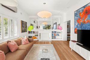 a living room with a couch and a tv at Superb 2-Bed Apartment Facing Rose Bay Marina in Sydney