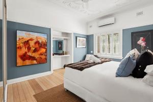 a bedroom with a bed with a painting on the wall at Superb 2-Bed Apartment Facing Rose Bay Marina in Sydney +12 photos
