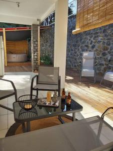 a patio with a table with drinks on it at charmante maison in Les Avirons