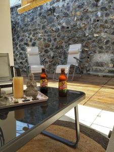 two bottles of beer sitting on top of a table at charmante maison in Les Avirons +6 photos