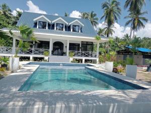a house with a swimming pool in front of a house at South Pearl Villas 