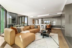 a living room with a couch and a table at Kangaroo Point Apartment by Urban Rest in Brisbane