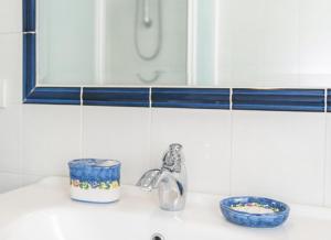 a bathroom counter with a sink and a mirror at Casa Blu Cobalto in Maiori