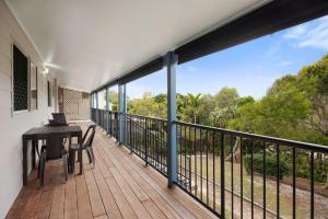a balcony with a table and chairs on it at Allamanda Sands in Peregian Beach