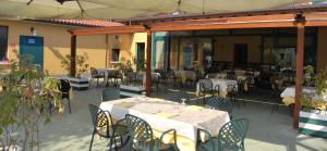 an outdoor patio with tables and chairs and tables and tablesearcher at Hotel Ristorante Morus in Burago di Molgora