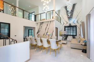 Un comedor con una mesa larga y sillas. en Psalms 23 Residence, en Bangkok
