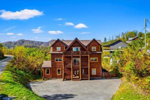 a large log home with a driveway at Indoor Pool, Volleyball Beach, Mountain View, Luxury in Gatlinburg +94 photos