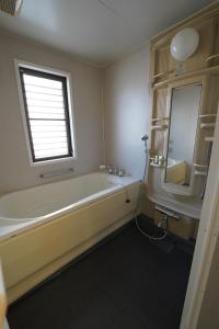 a bathroom with a tub and a sink and a window at 浜ノ町瀬戸凪 in Takamatsu +17 photos