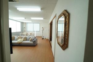 a living room with a couch and a mirror at 浜ノ町瀬戸凪 in Takamatsu
