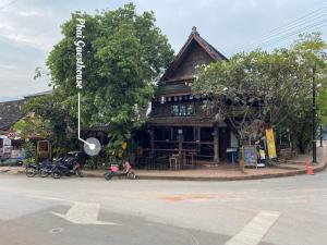 a building with motorcycles parked in front of it at PHAI GUESTHOUSE in Luang Prabang
