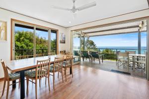 a dining room with a table and chairs at Claytons 7 by Discover Stradbroke in Point Lookout