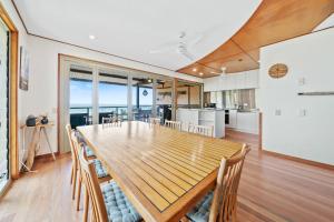 a kitchen and dining room with a wooden table and chairs at Claytons 7 by Discover Stradbroke in Point Lookout
