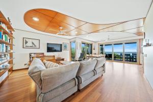 a living room with two couches and a television at Claytons 7 by Discover Stradbroke in Point Lookout