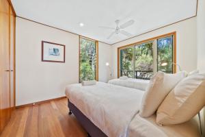 a bedroom with two beds and a window at Claytons 7 by Discover Stradbroke in Point Lookout