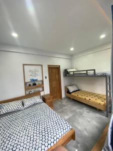a bedroom with two bunk beds in a room at Kidapawan Staycation 2 in Manongol