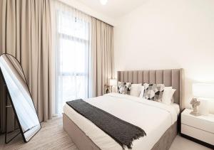 a white bedroom with a large bed and a window at Lux Escape, Burj Crown Opera View, Near Dubai Mall in Dubai +45 photos