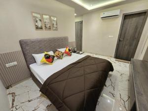 a bedroom with a bed with pillows on it at Zipcode Stay in Agra