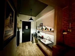 a kitchen with a sink and a black door at Rent V38 #420 friendly Thailand in Bangkok