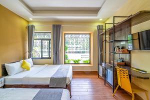 Postel nebo postele na pokoji v ubytování Richy Dalat Hotel