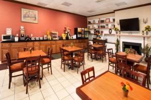 a restaurant with tables and chairs and a fireplace at Days Inn by Wyndham Rome Downtown in Rome