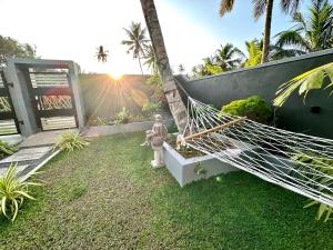 a hammock in a garden with a fire hydrant at The Green Heaven Villa in Ambalangoda